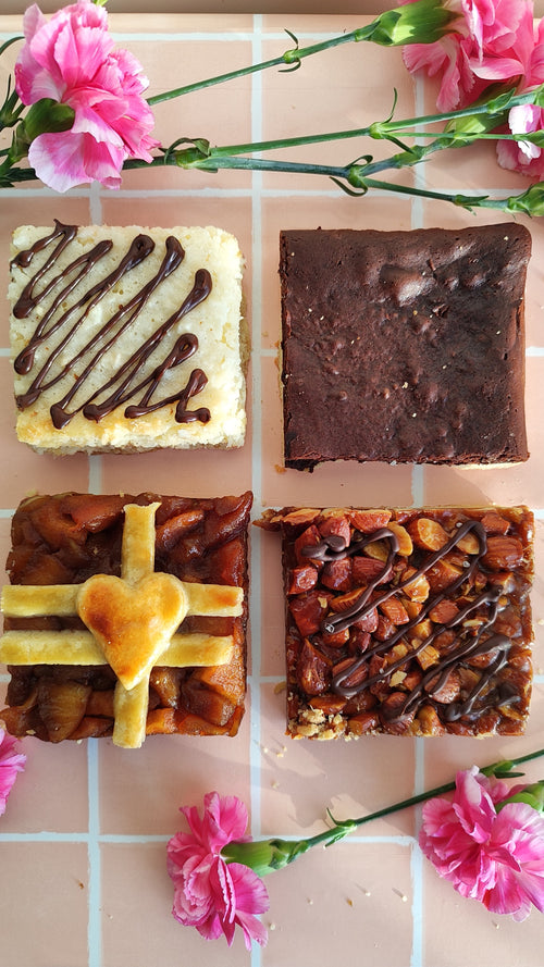 Four different types of pie bars on a checkered tablecloth with pink flowers.